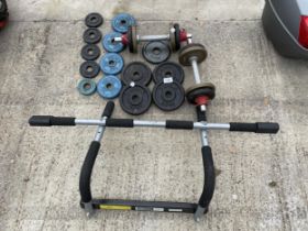 AN ASSORTMENT OF WEIGHT LIFTING WEIGHTS AND A PULL UP RACK