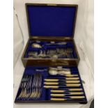 A VINTAGE OAK CASED WALKER AND HALL SILVER PLATED CANTEEN OF CUTLERY