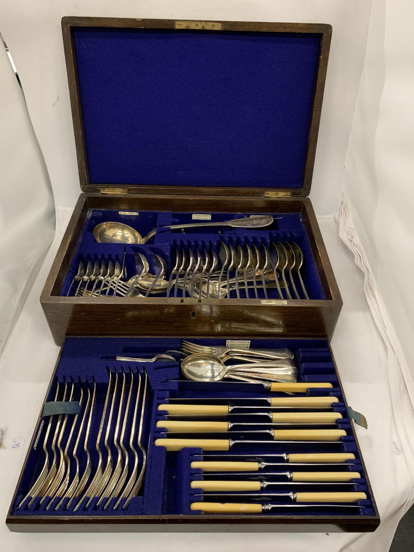 A VINTAGE OAK CASED WALKER AND HALL SILVER PLATED CANTEEN OF CUTLERY