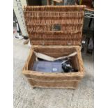 A WICKER TACKLE BASKET AND AN ASSORTMENT OF FISHING TACKLE TO INCLUDE REELS AND FLOATS ETC