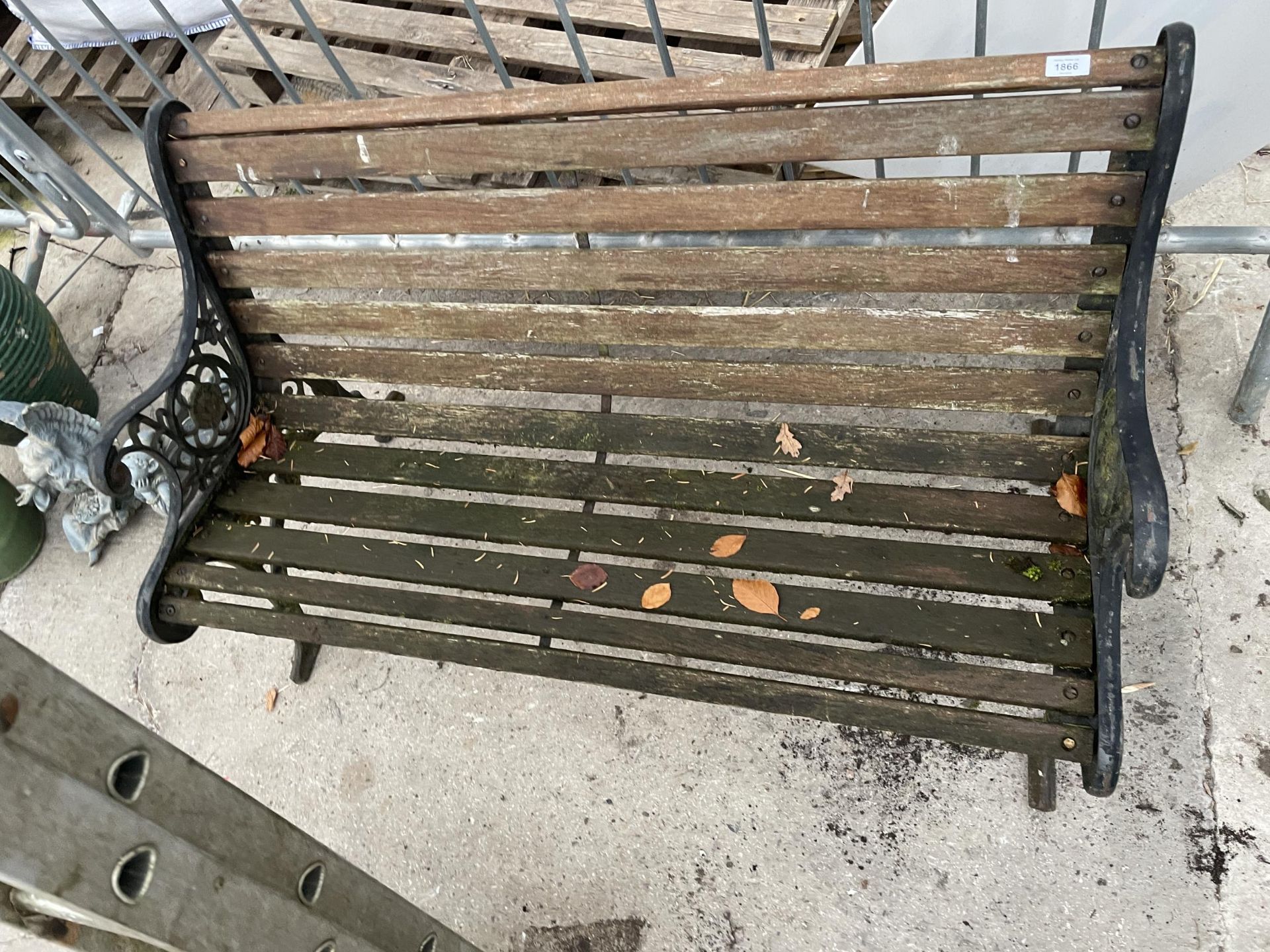 A WOODEN SLATTED GARDEN BENCH WITH CAST BENCH ENDS - Image 3 of 3