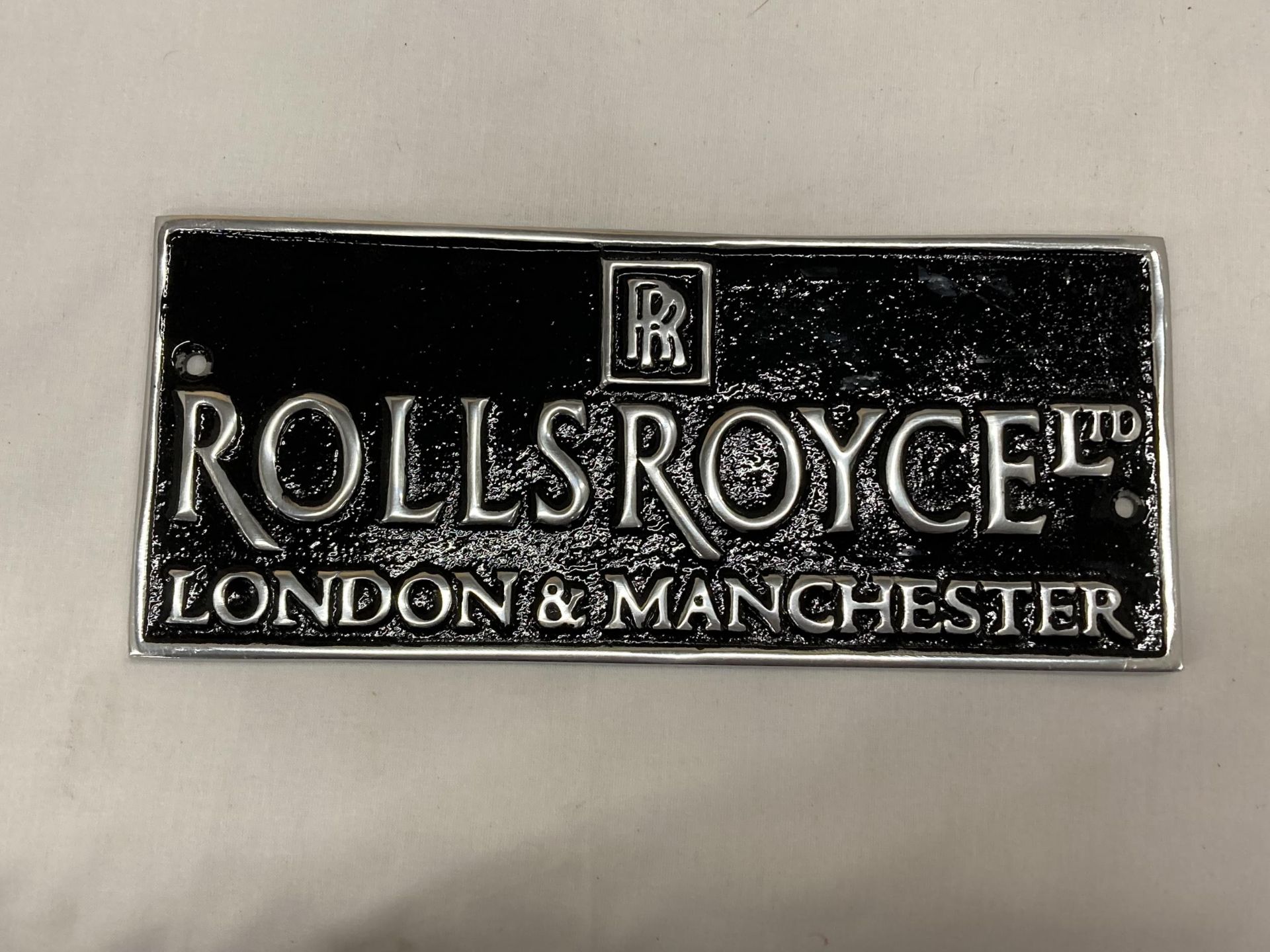 A BLACK AND CHROME ROLLS-ROYCE LONDON AND MANCHESTER SIGN, 15CM X 11CM