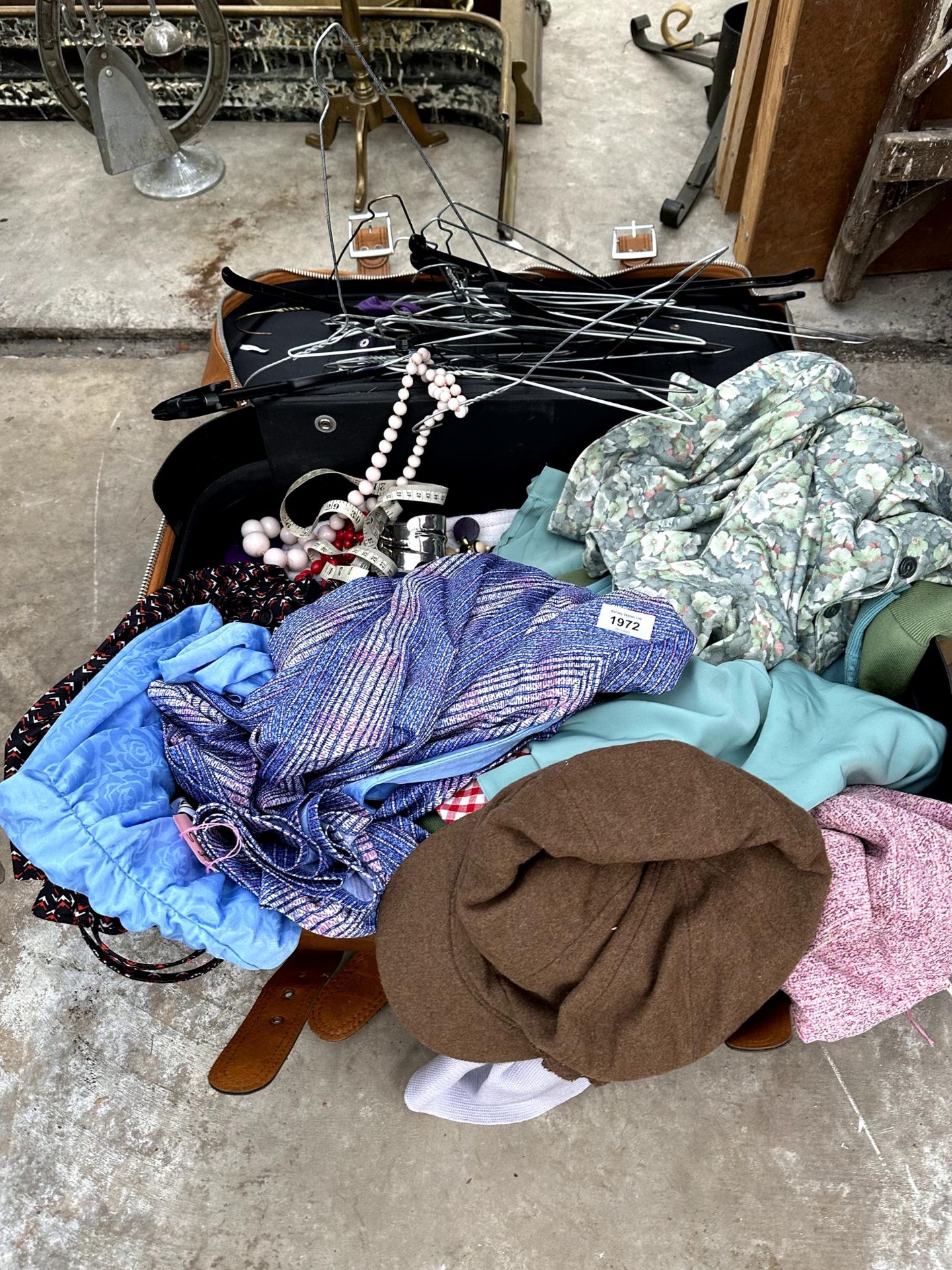 A SUITCASE CONTAINING AN ASSORTMENT OF CLOTHES