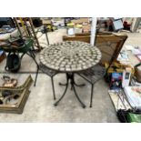 A BISTRO SET COMPRISING OF A ROUND TILE TOP TABLE AND TWO METAL CHAIRS