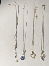 FOUR ASSORTED SILVER NECKLACES WITH PENDANTS