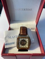 A MASTERTIME SQUARE FACED SKELETON AUTOMATIC WRIST WATCH IN PRESENTATION BOX (IN NEED OF NEW