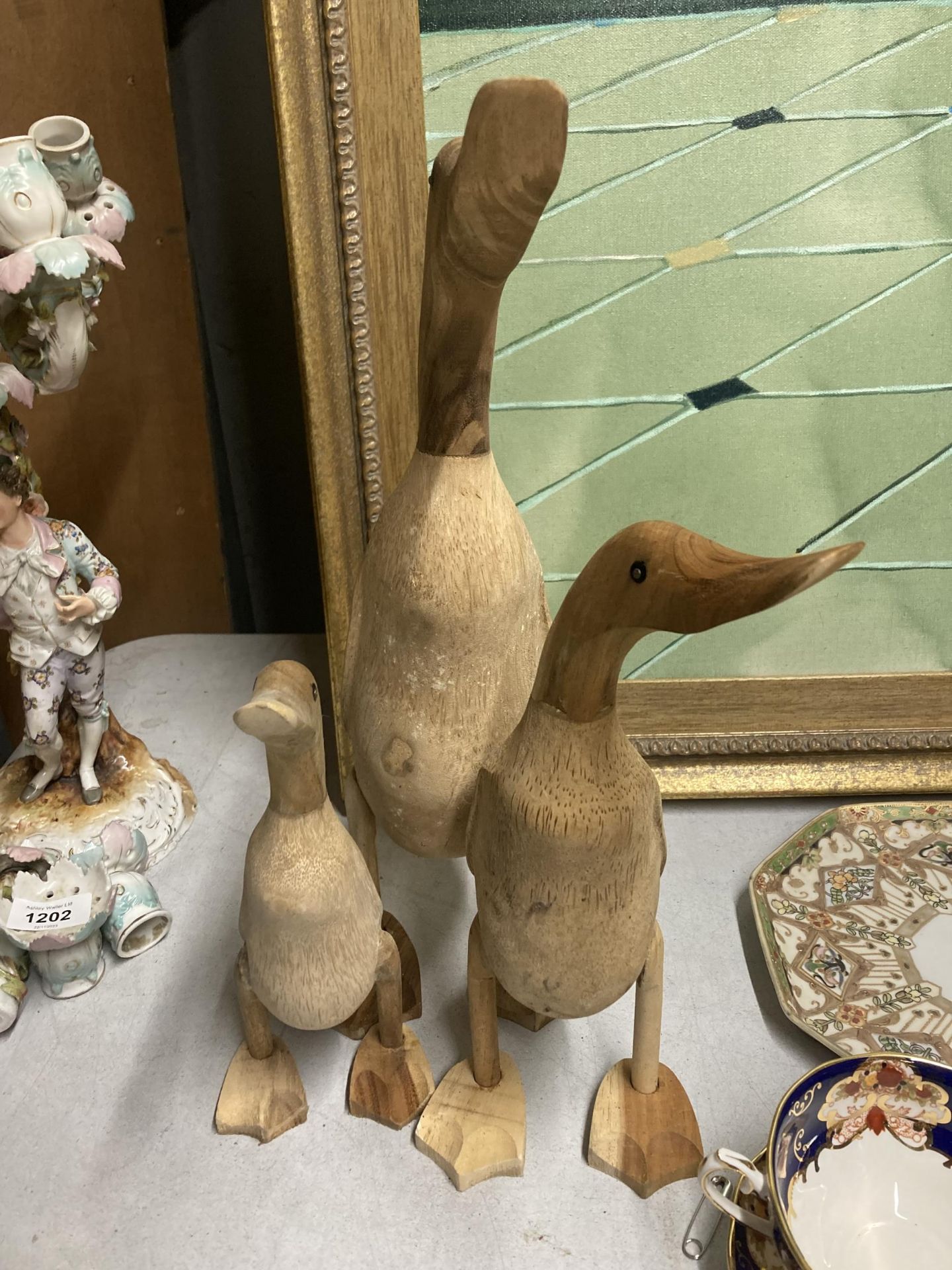 A GROUP OF THREE WOODEN DUCK FIGURES