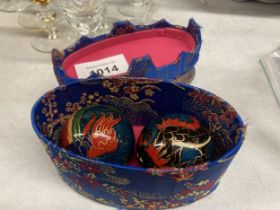 TWO CASED ORNATE ORIENTAL BALLS