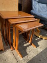 A RETRO TEAK NEST OF THREE TABLES