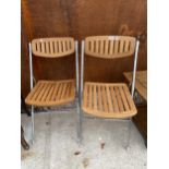 A PAIR OF SLATTED ELM AND OAK FOLDING CHAIRS ON POLISHED CHROME FRAME