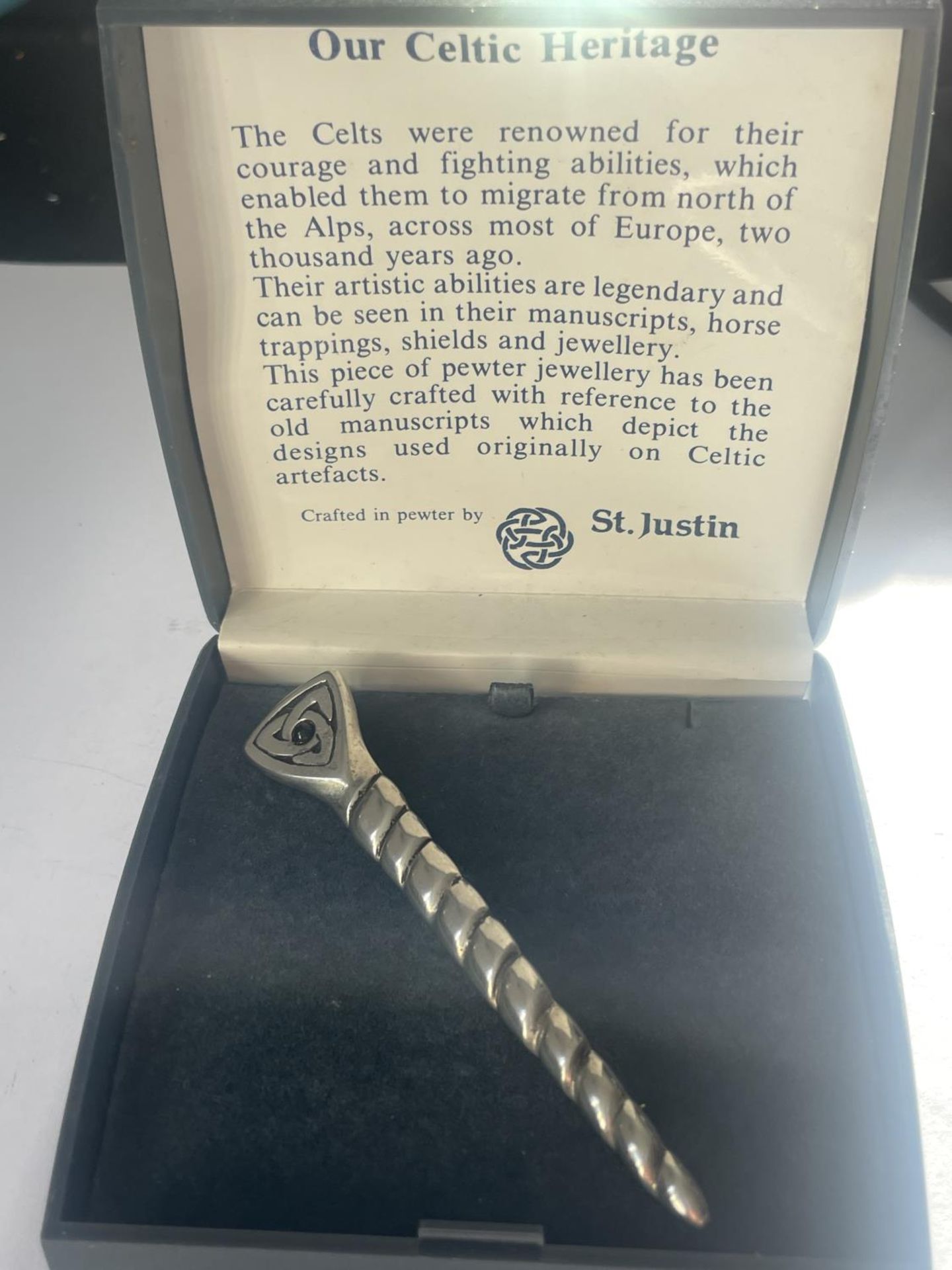 A ST JUSTIN PEWTER PIN BROOCH