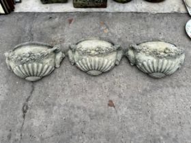 THREE DECORATIVE CONCRETE WALL PLANTERS