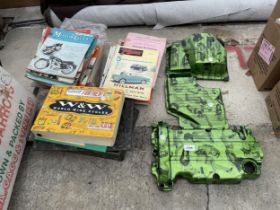 THREE DECORATIVE PLASTIC COVERS AND AN ASSORTMENT OF MANUALS