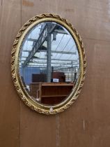 A MODERN OVAL GILT WALL MIRROR, 27 X 21"