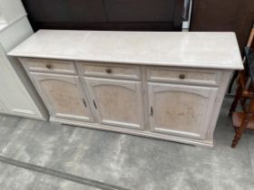 A MODERN LIMED SIDEBOARD ENCLOSING THREE DRAWERS AND THEE CUPBOARDS, 67" WIDE