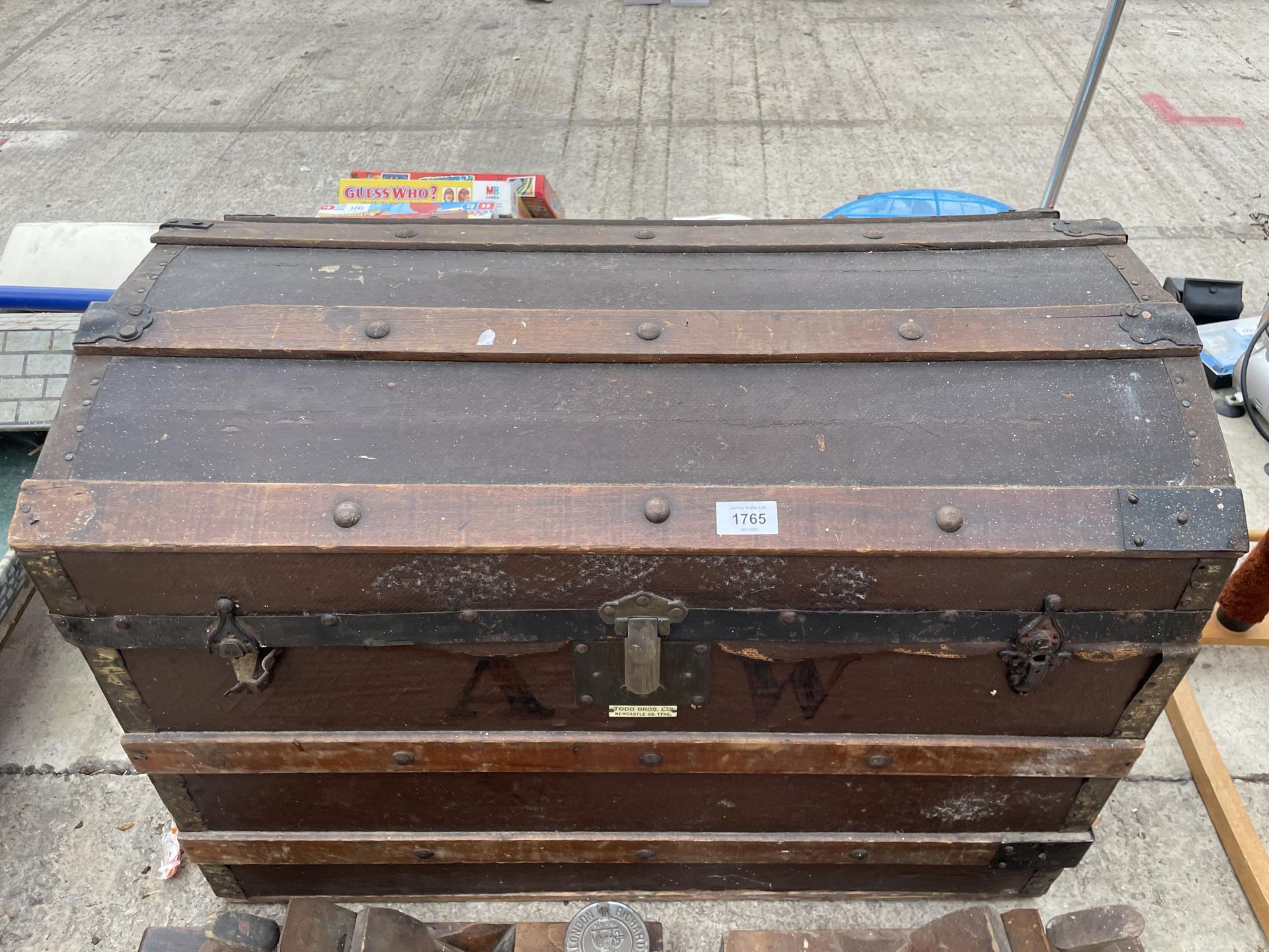 A VINTAGE WOODEN DOME TOP TRUNK BEARING THE LABEL TODD BROS