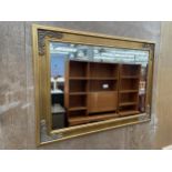 A MODERN GILT FRAMED BEVEL EDGE WALL MIRROR, 43 X 31"