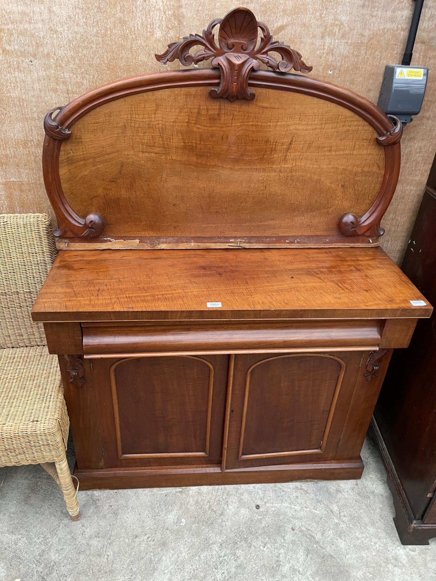 A VICTORIAN MAHOGANY CHIFFONIER WITH CARVED FOLIATE BACK