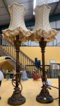 A PAIR OF ART NOUVEAU DESIGN METAL TABLE LAMPS AND SHADES WITH LEAF DESIGN BASES