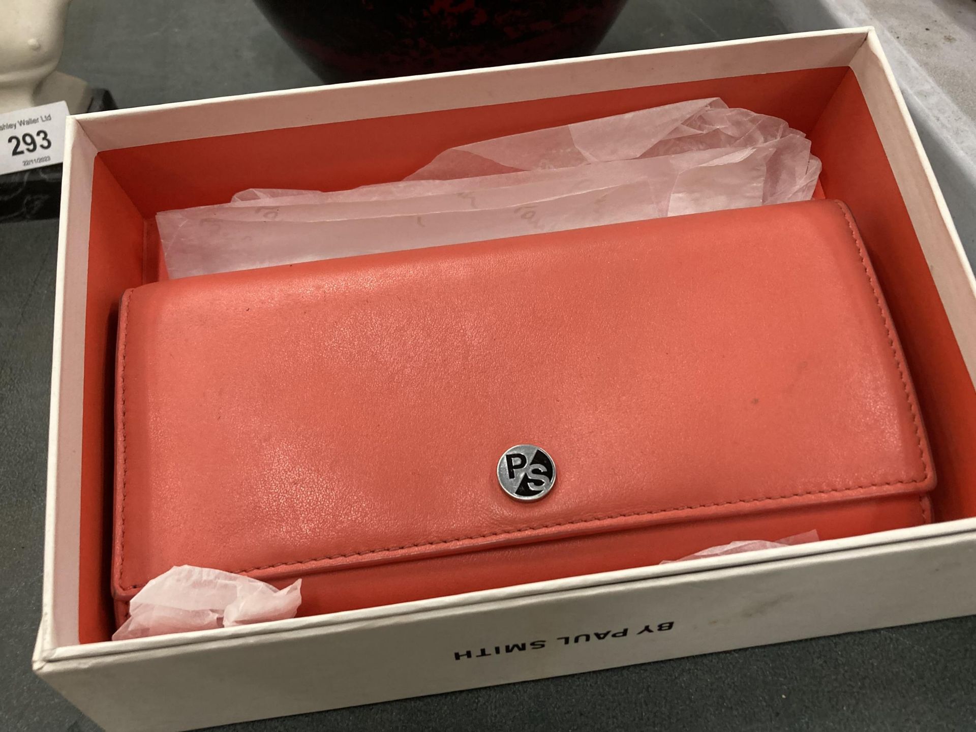 A BOXED PAUL SMITH ORANGE LEATHER PURSE