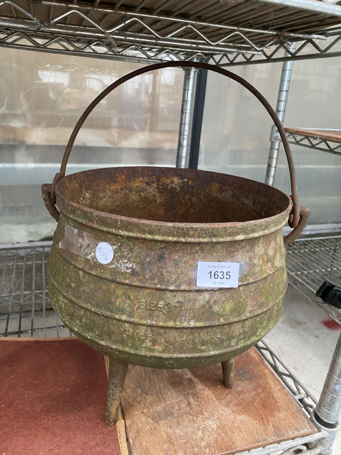 A VINTAGE CAST IRON TRI FOOTED CAULDRON POT