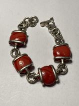 A SILVER AND RED STONE BRACELET