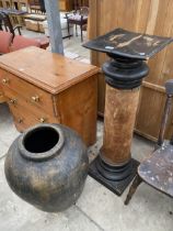 AN EBONISED PEDESTAL AND PAPIER MACHE URN