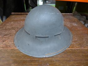 A BRITISH WORLD WAR II HOME FRONT CIVIL DEFENCE PAINTED STEEL HELMET AND LINER DATED 1941