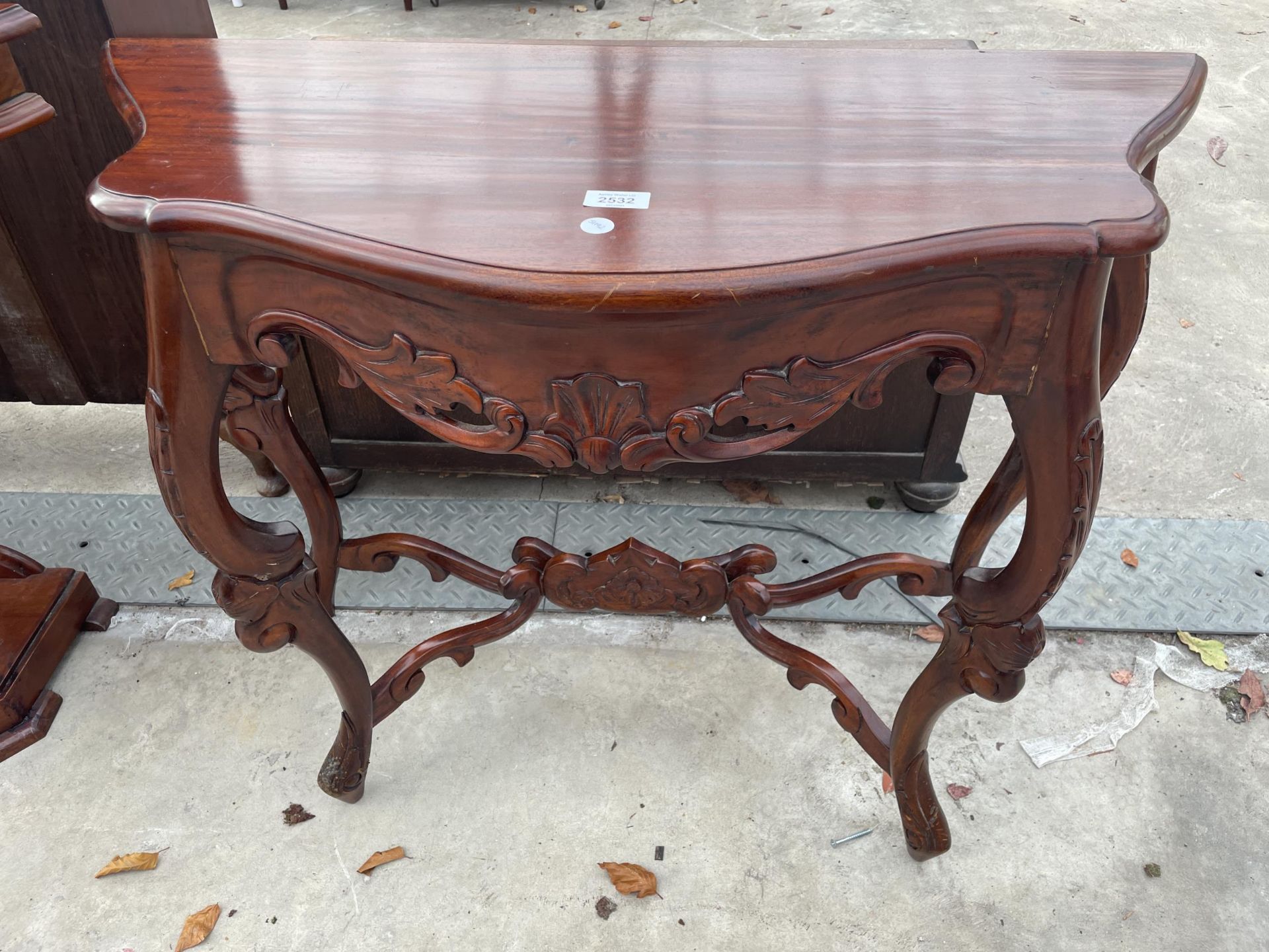 A VICTORIAN STYLE CONSOLE TABLE WITH CARVED FRIEZE AND STRECHERS, 35" WIDE