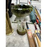 A SMALL CONCRETE BIRDBATH WITH CHERUB PEDESTAL BASE