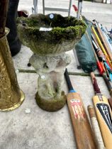 A SMALL CONCRETE BIRDBATH WITH CHERUB PEDESTAL BASE