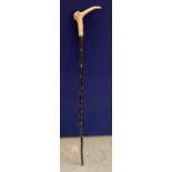 A VINTAGE EBONISED WALKING STICK WITH HORN EFFECT BIRD TOP WITH JEWELLED DESIGN EYES