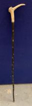 A VINTAGE EBONISED WALKING STICK WITH HORN EFFECT BIRD TOP WITH JEWELLED DESIGN EYES