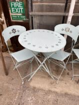 A MODERN METALWARE PAINTED FOLDING PATIO TABLE AND TWO CHAIRS