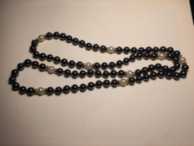 A BLACK PEARL AND POSSIBLY GOLD NECKLACE