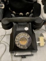 A VINTAGE BAKELITE TELEPHONE WITH PULL OUT TRAY AND HOLMES CHAPEL NUMBER