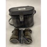 A PAIR OF BRASS BINOCULARS IN A LEATHER CASE