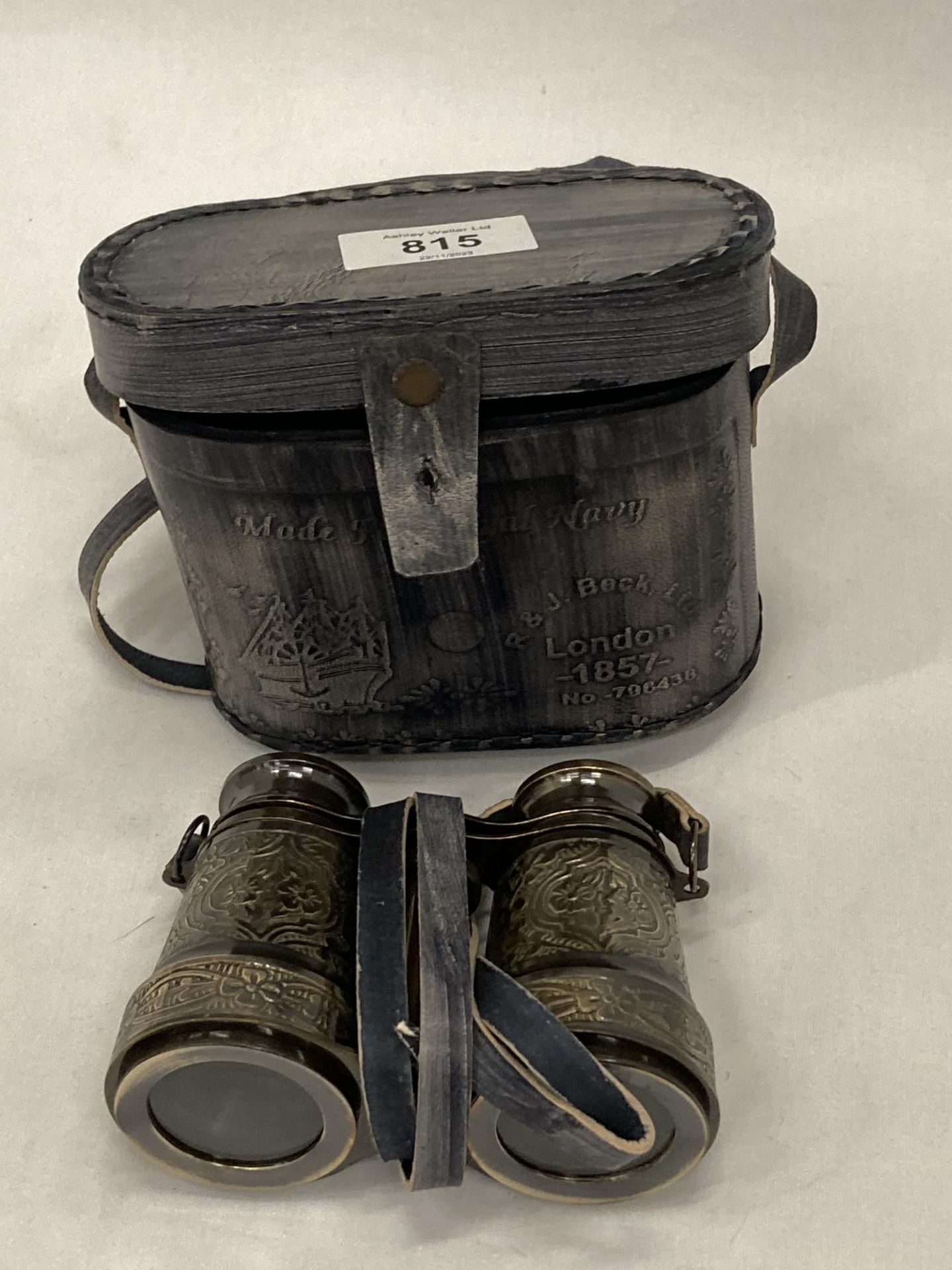 A PAIR OF BRASS BINOCULARS IN A LEATHER CASE