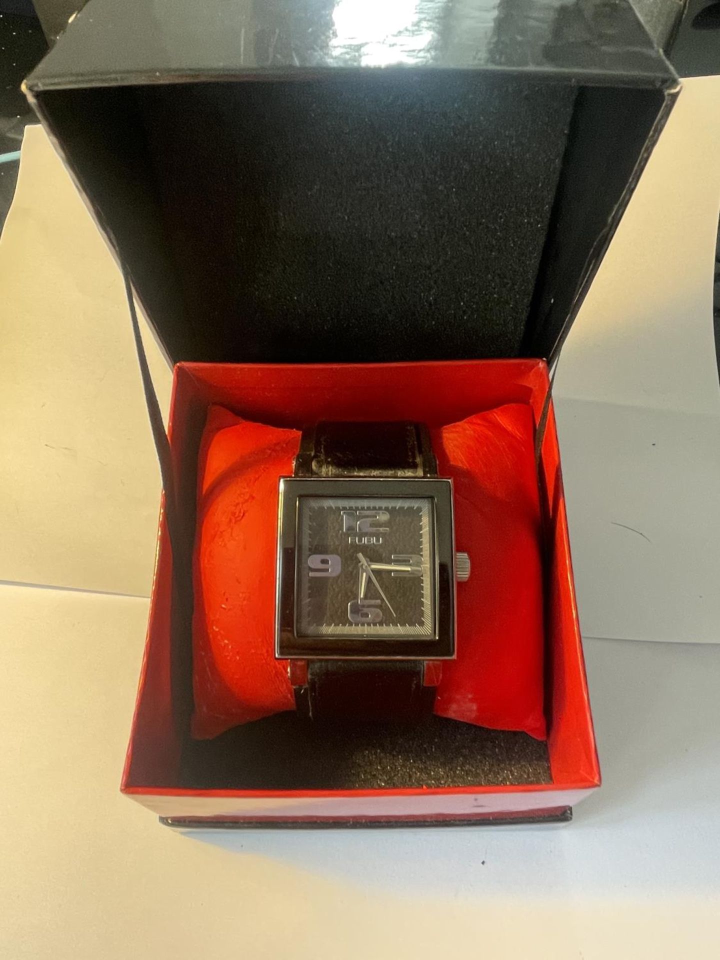 AN AS NEW AND BOXED FUBU WRISTWATCH SEEN WORKING BUT NO WARRANTY