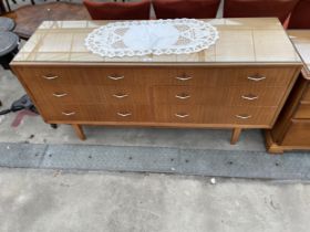 A RETRO TEAK SIDEBOARD ENCLOSING TWO SHORT AND FIVE LONG DRAWERS, 60" WIDE