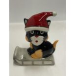 A LORNA BAILEY HAND PAINTED AND SIGNED CAT ON A SLEDGE