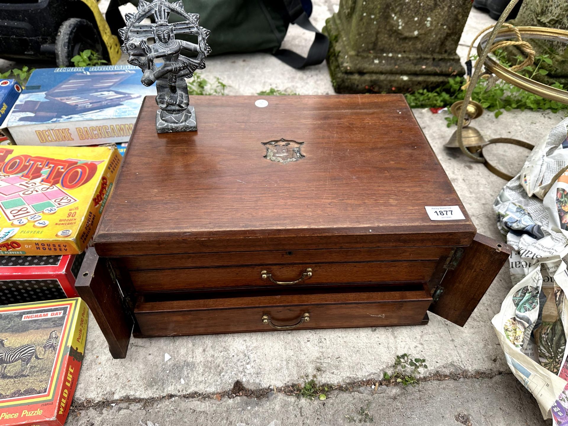 A MINIATURE OAK CHEST OF TWO DRAWERS AND A HINDU FIGURE