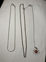 THREE SILVER NECKLACES ONE WITH A STAR PENDANT