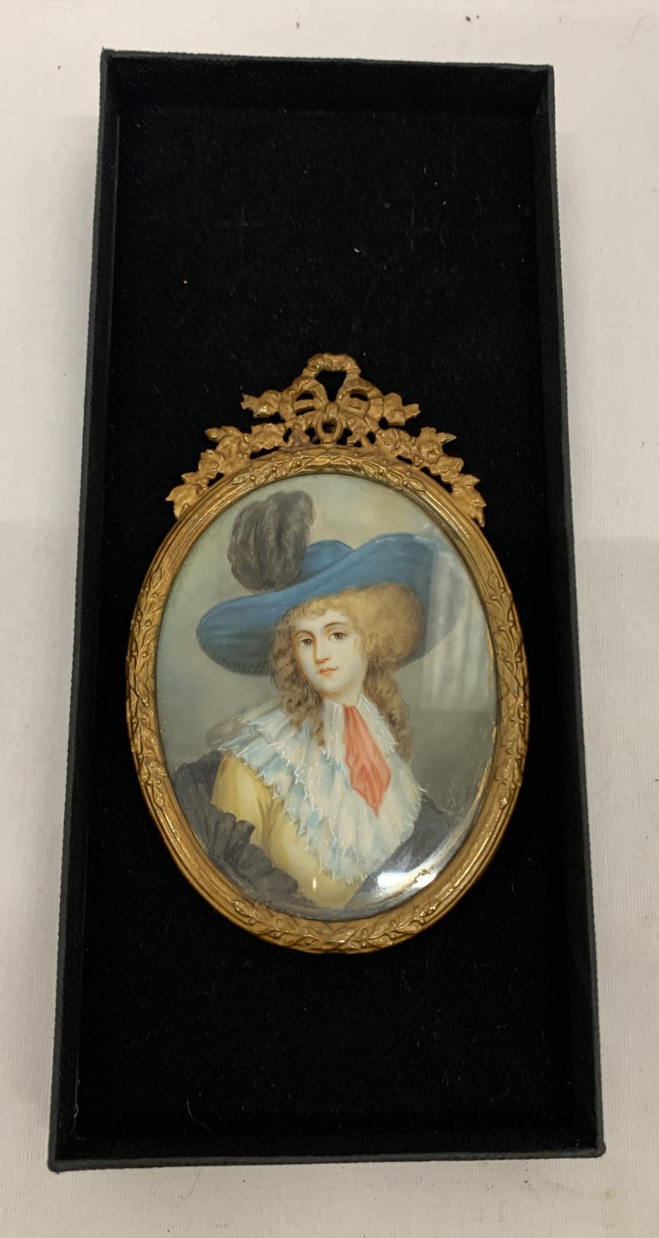 AN ANTIQUE (APPROX 1870) GILT FRAMED PORTRAIT MINIATURE OF A LADY, LABEL TO REVERSE, LENGTH 11CM