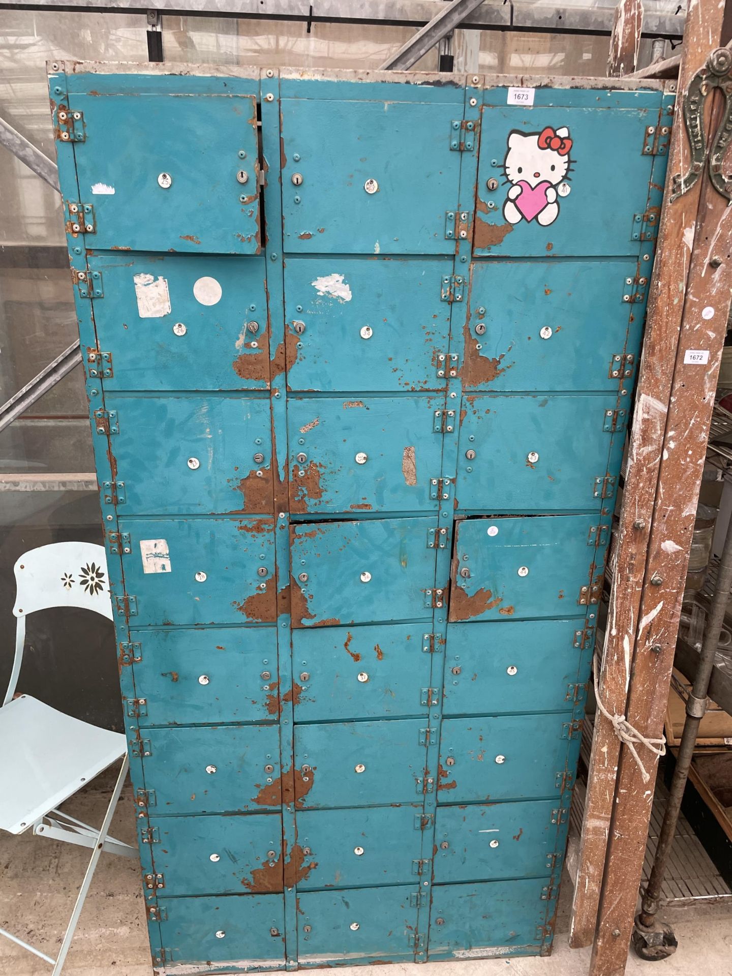 A LARGE METAL 24 SECTION LOCKER UNIT