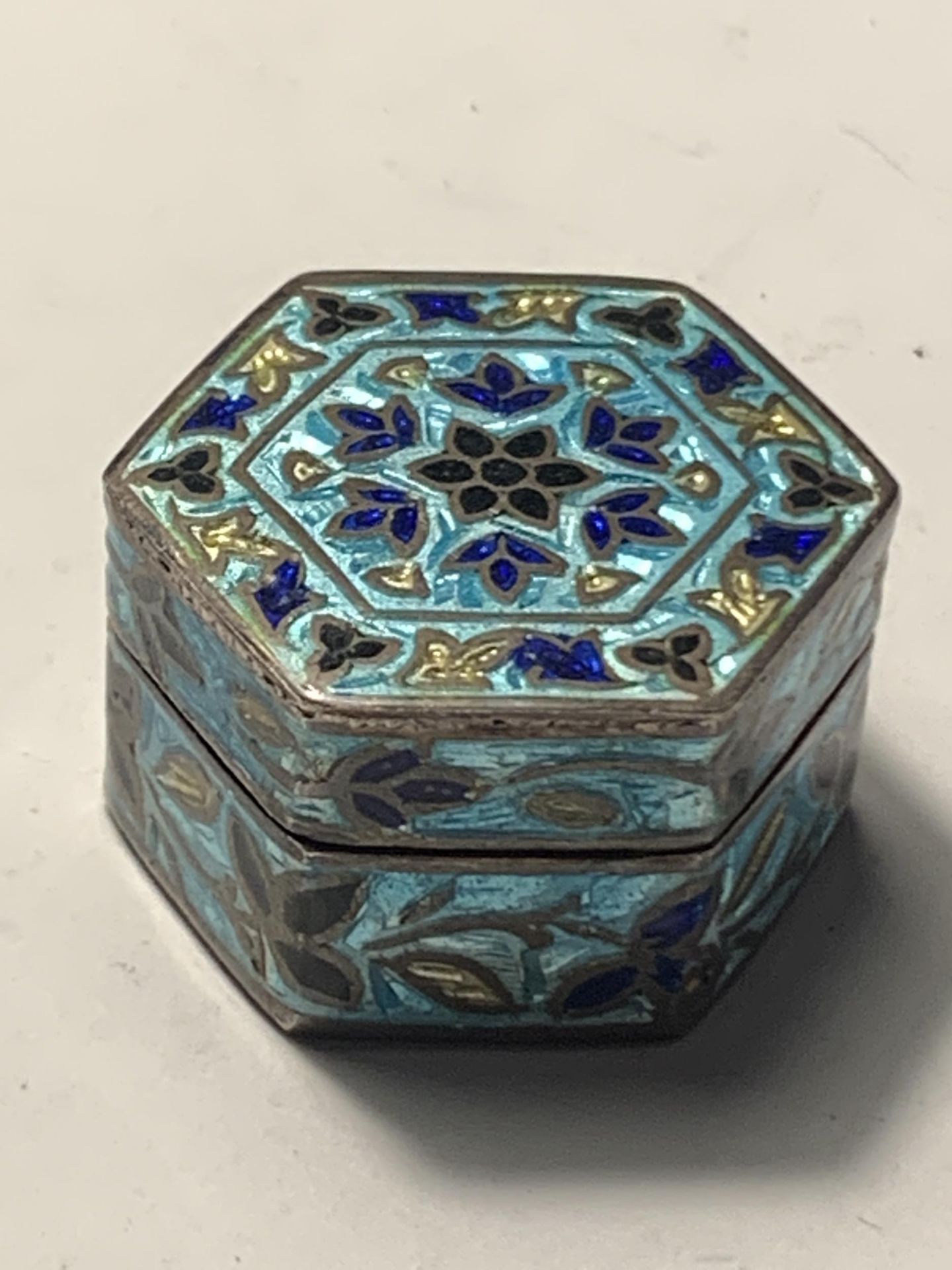 A SILVER AND ENAMELLED HEXAGONAL PILL BOX