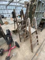 TWO VINTAGE WOODEN STEP LADDERS TO INCLUDE A THREE RUNG AND A FOUR RUNG