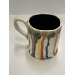 AN ANITA HARRIS HAND PAINTED AND SIGNED IN GOLD FUSION SPLASH MUG