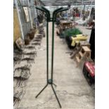 A RETRO METAL TRIPOD COAT AND HAND STAND