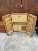 A RETRO TEAK HOME OFFICE ENCLOSING FOUR DRAWERS AND DROP DOWN BUREAU FLAP